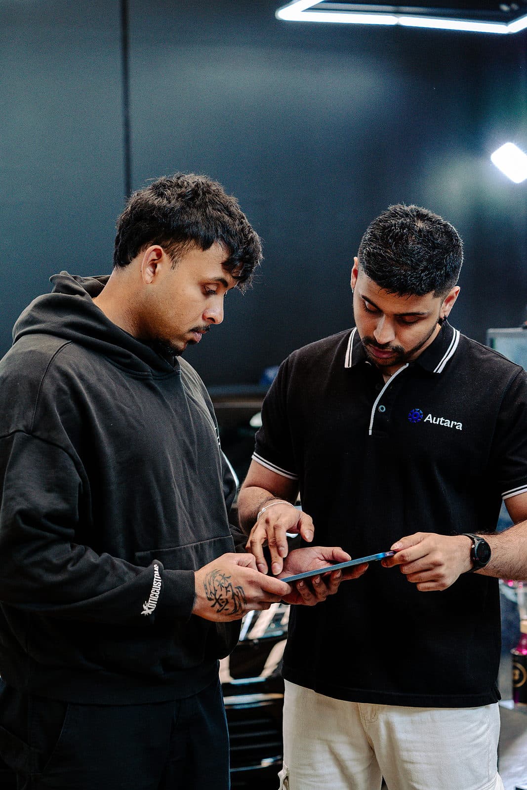 An Autara team member reviewing work on a tablet in the workshop