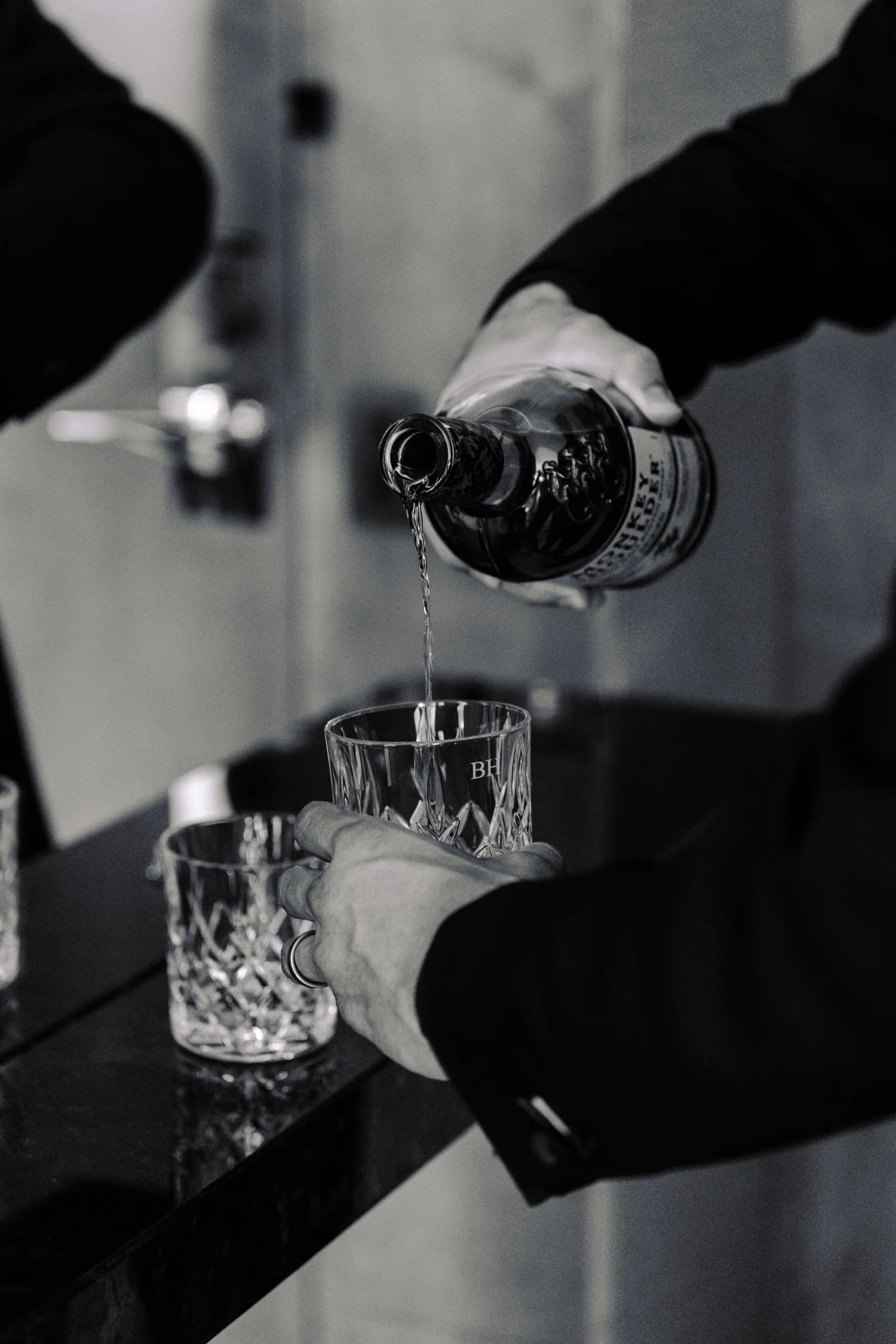A drink being poured into cut-glass tumblers before the event.