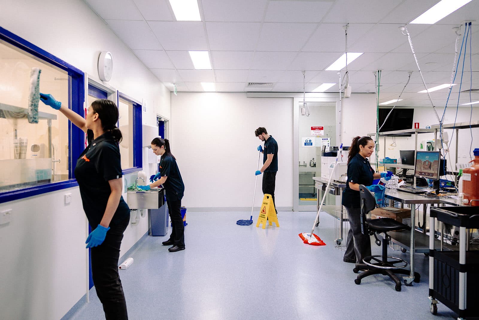 Kango Facility Services staff cleaning a laboratory corridor