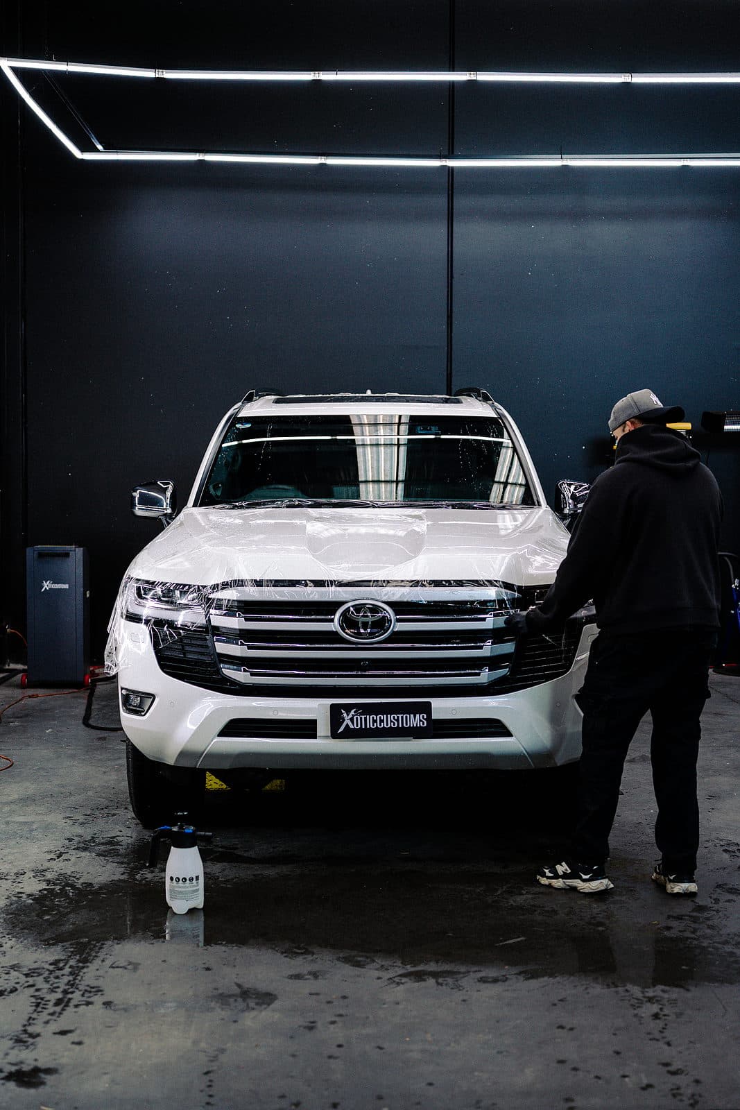 A LandCruiser being wrapped in the Xotic Customs workshop