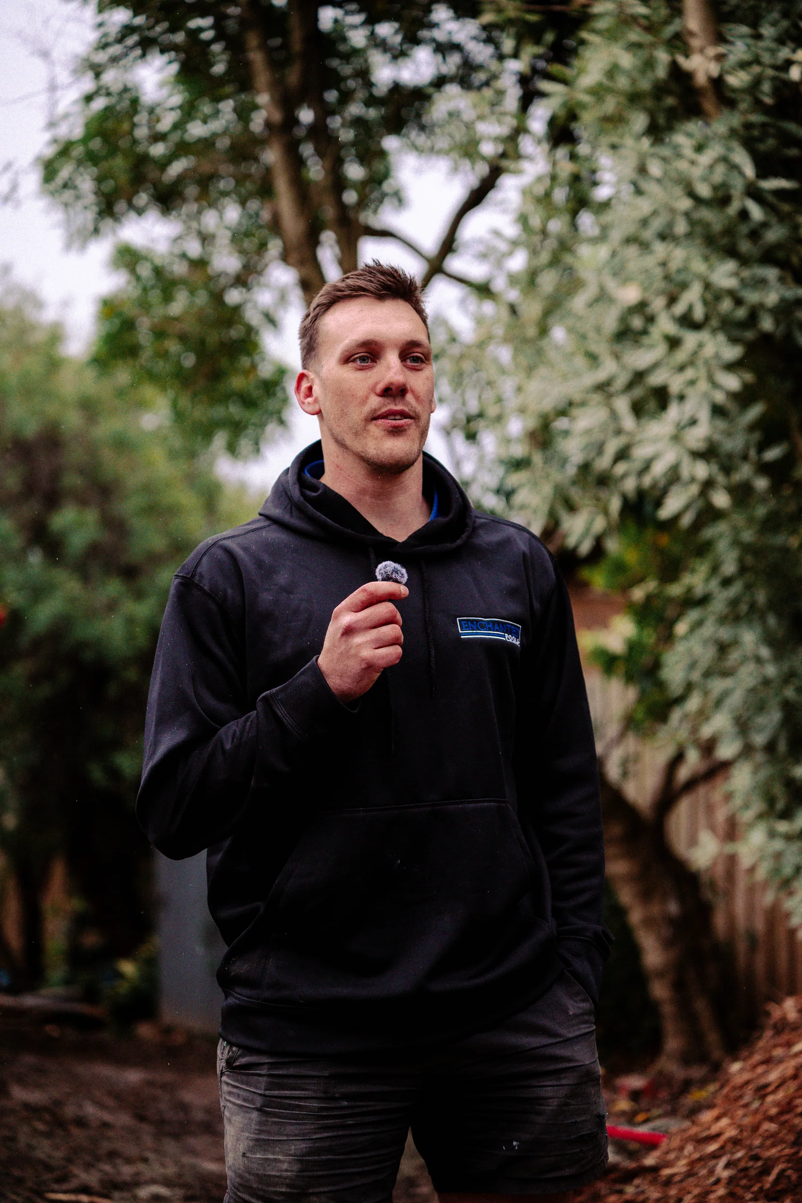 An Enchanted Pools team member speaking on camera at a pool installation site