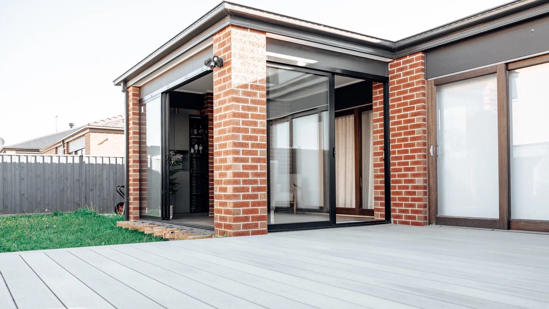 Brick and glazed lifestyle room opening onto a deck in Cranbourne.