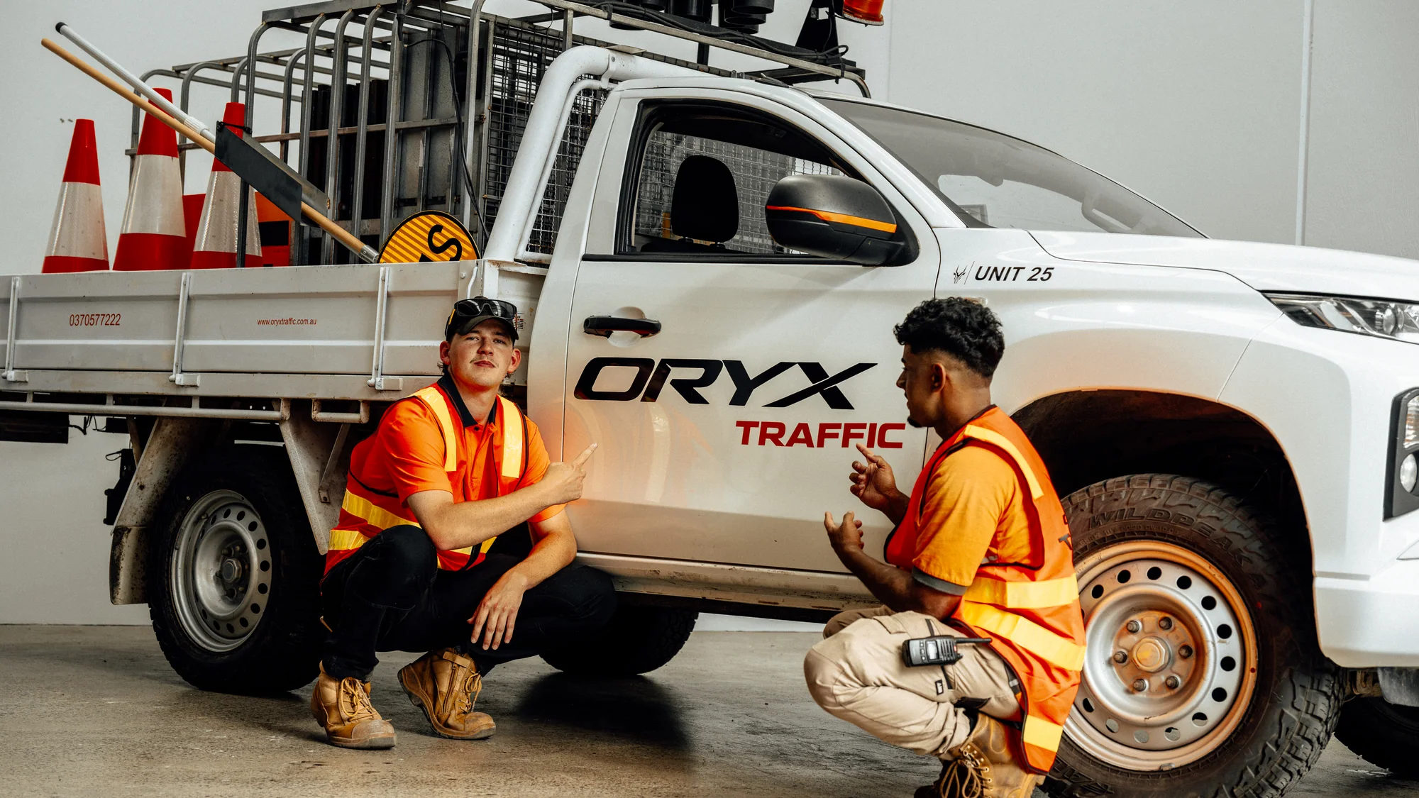 Oryx Traffic crew together beside a work vehicle