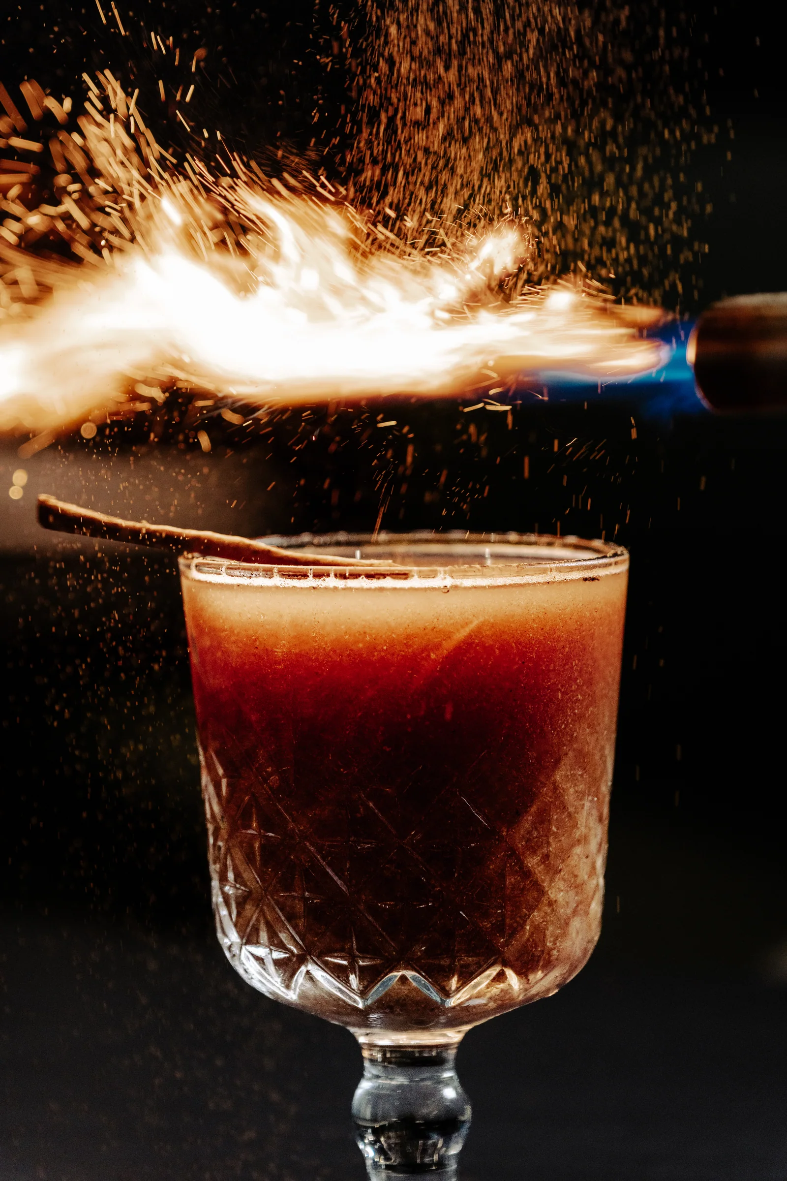 A cocktail with a glowing garnish at Pearl by P&D