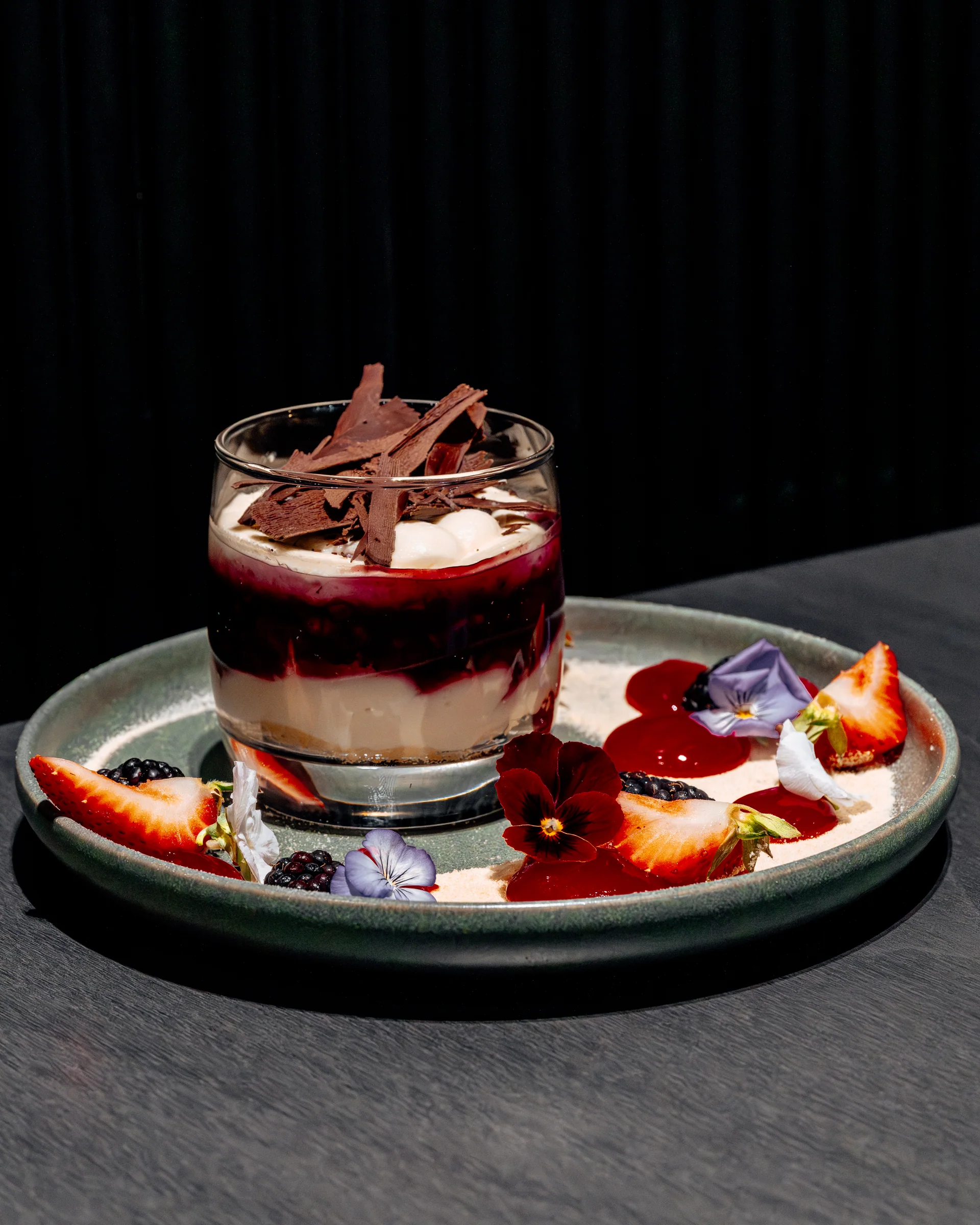 A plated dessert with berries at Pearl by P&D